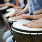 women playing djembe