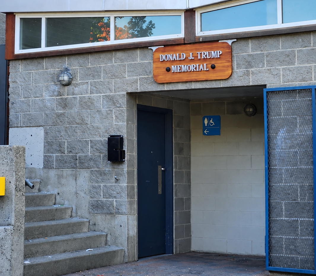 Donald J Trump Memorial sign above an outdoor washroom building